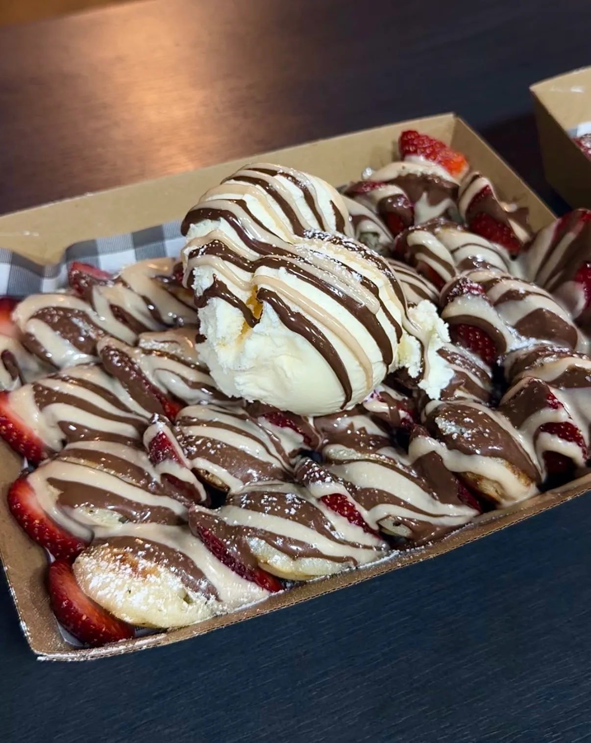 Dutch pancakes with fresh strawberries, ice-cream and chocolate drizzle