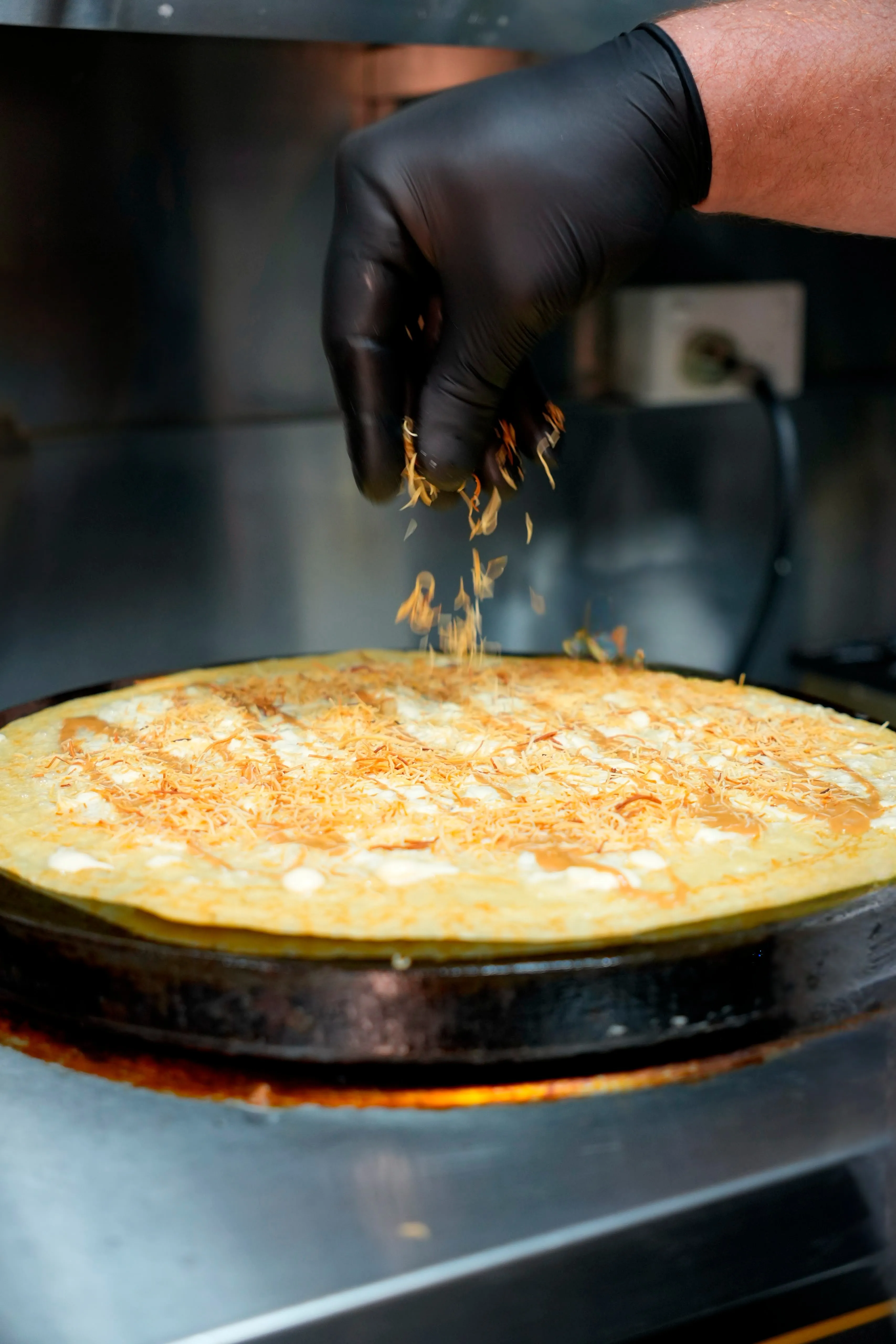 A crepe being finished fresh at Açaí World